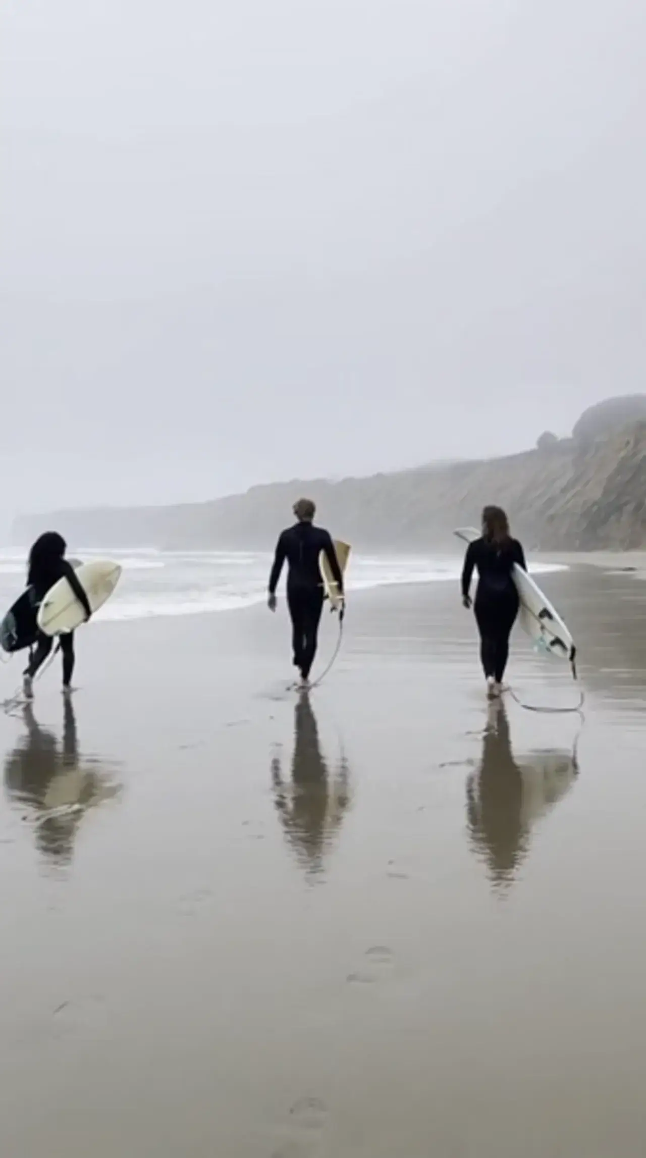 Text to Video example: vertical misty-beach surfers video for short-form hooks