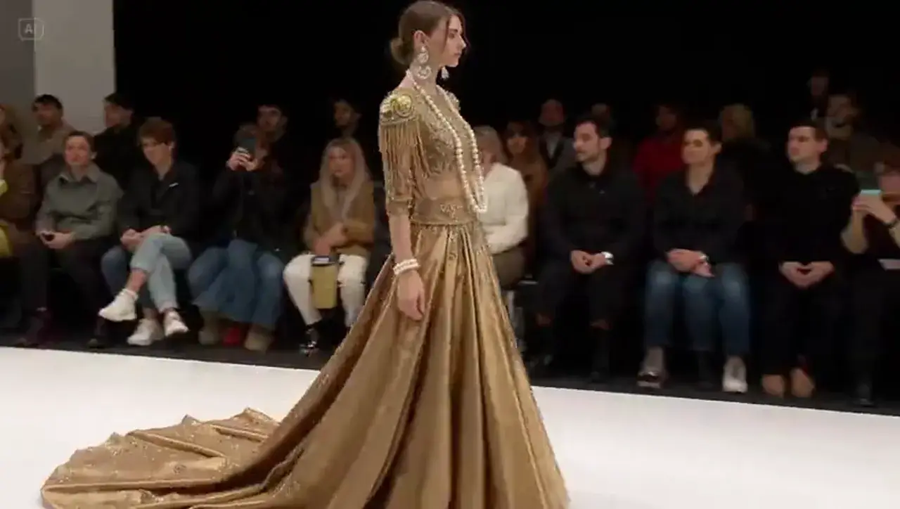 Text to Video example: golden-gown runway walk for fashion and kinetic motion opens