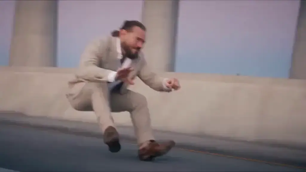 Reference video of an elevated highway chase: one person rides low on an invisible motorbike with fists forward while another follows on a pursuit vehicle