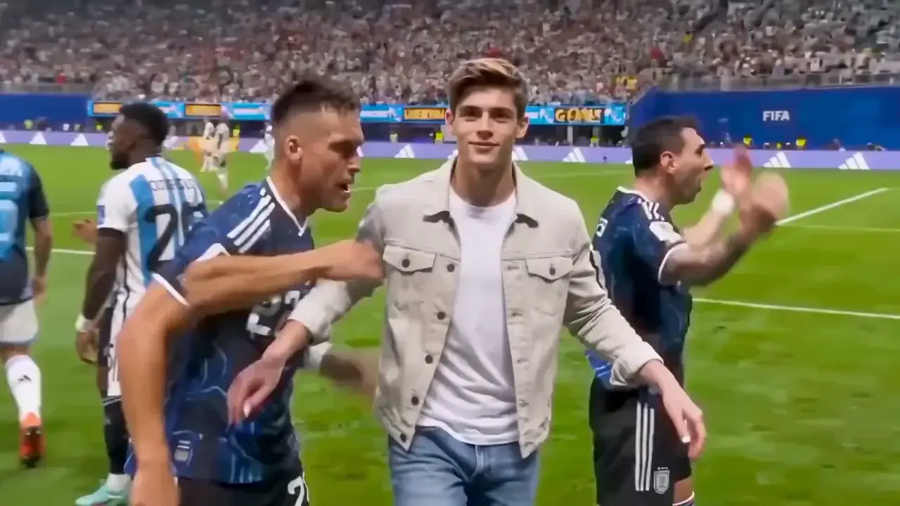 MixVio sample of a stadium celebration: a young man in a beige jacket cups both hands behind his ears and sends a kiss toward the crowd