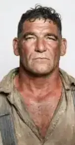 Reference to Video example: a man in a worn shirt and suspenders