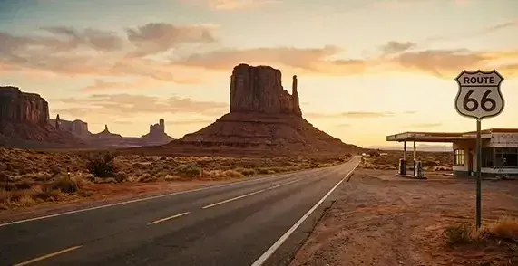 Reference to Video example: a desert highway with a Route 66 sign and a gas station
